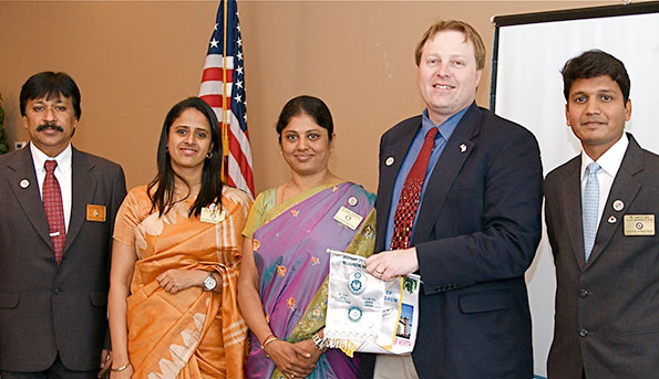 Brad and the 4 Rotarians from India exchanging flags